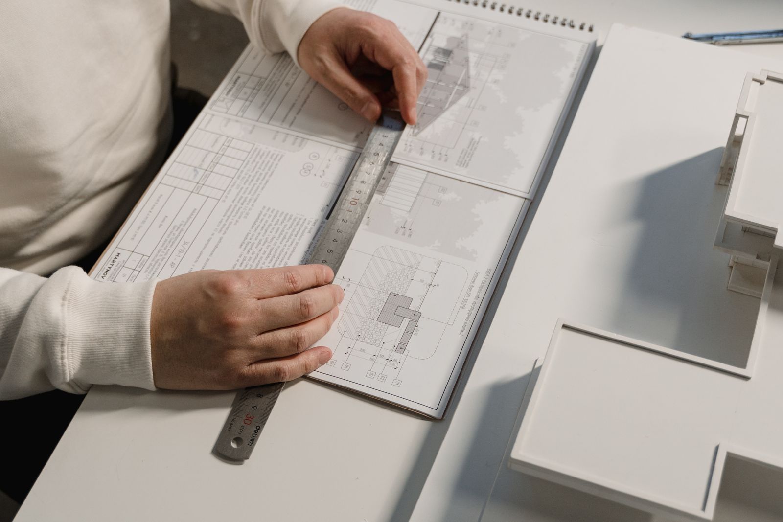 Hands drafting a plan