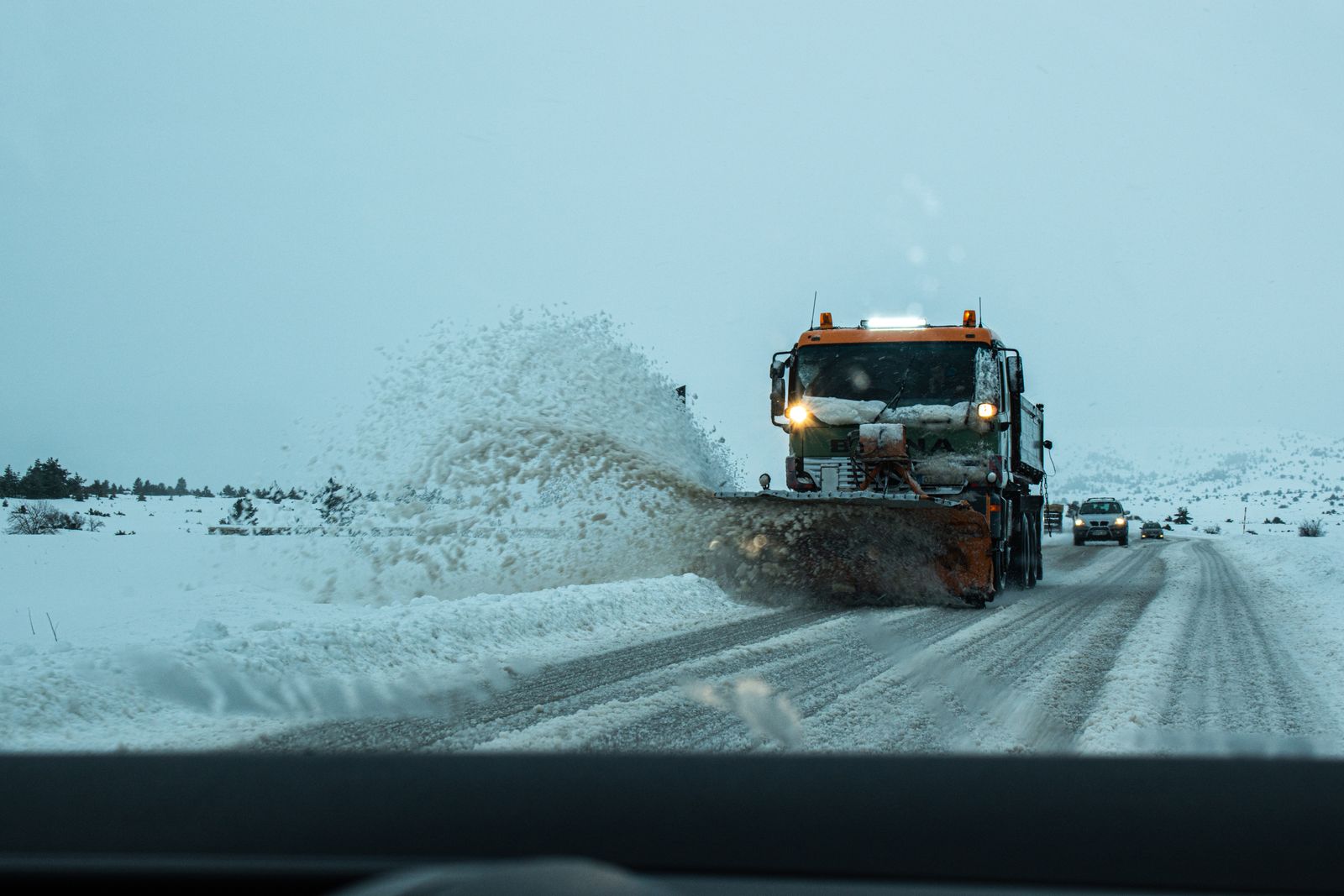 Plow clearing a snow-covered road