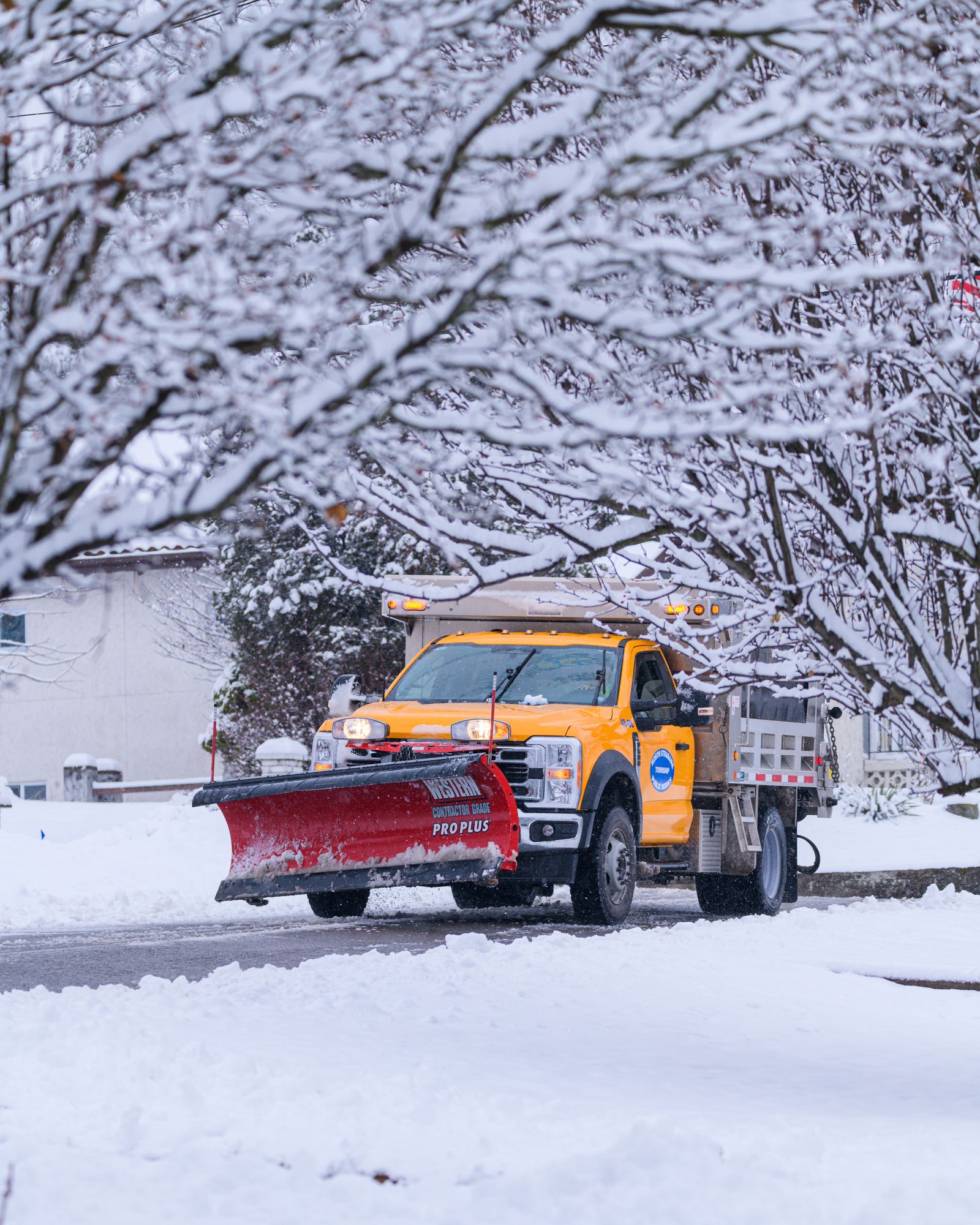 Snow plow clearing a residential street