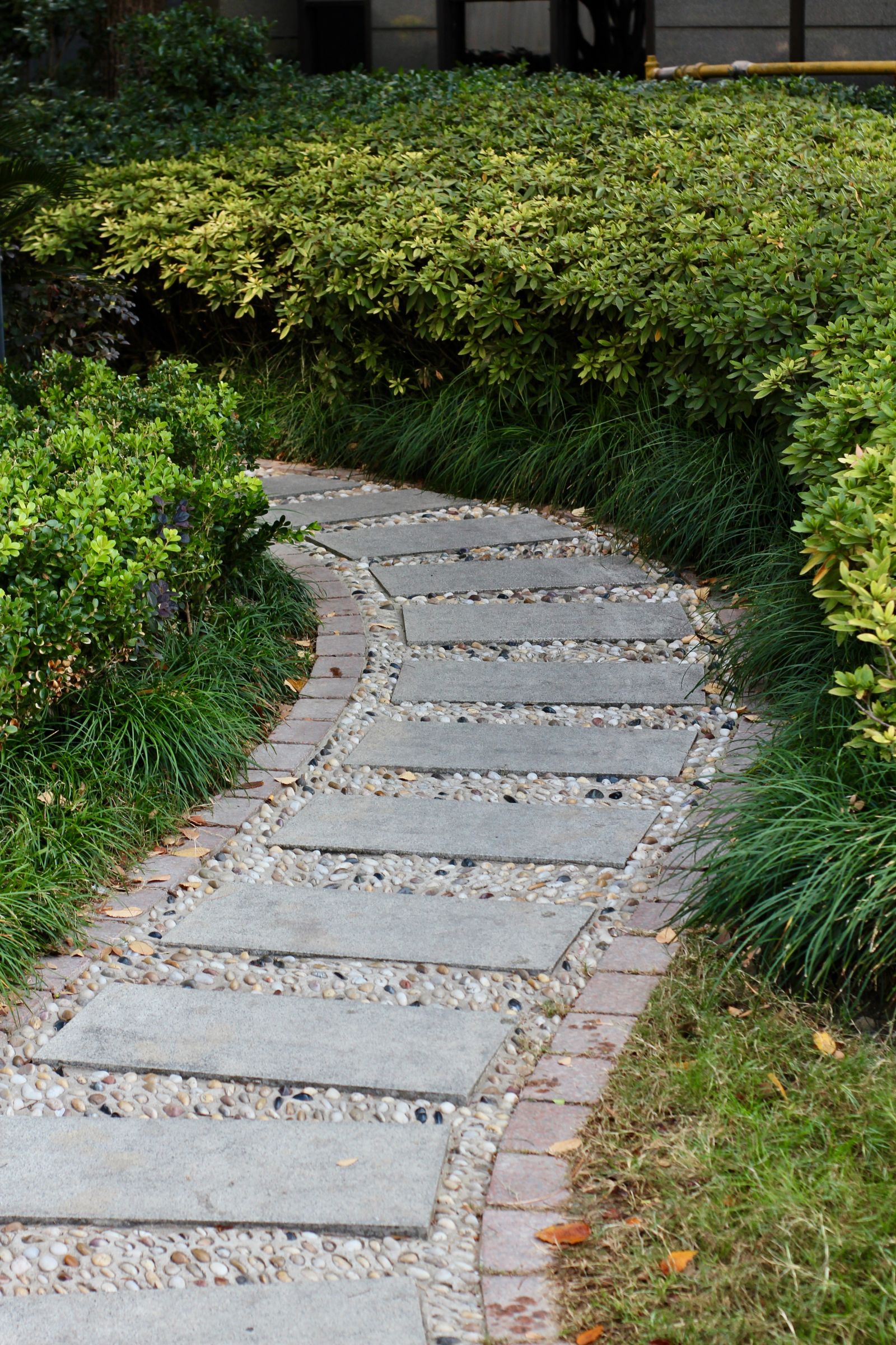 Curved stone pathway through garden beds