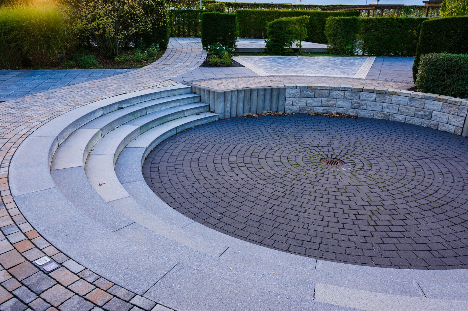 Curved stone steps leading down to a circular paved area