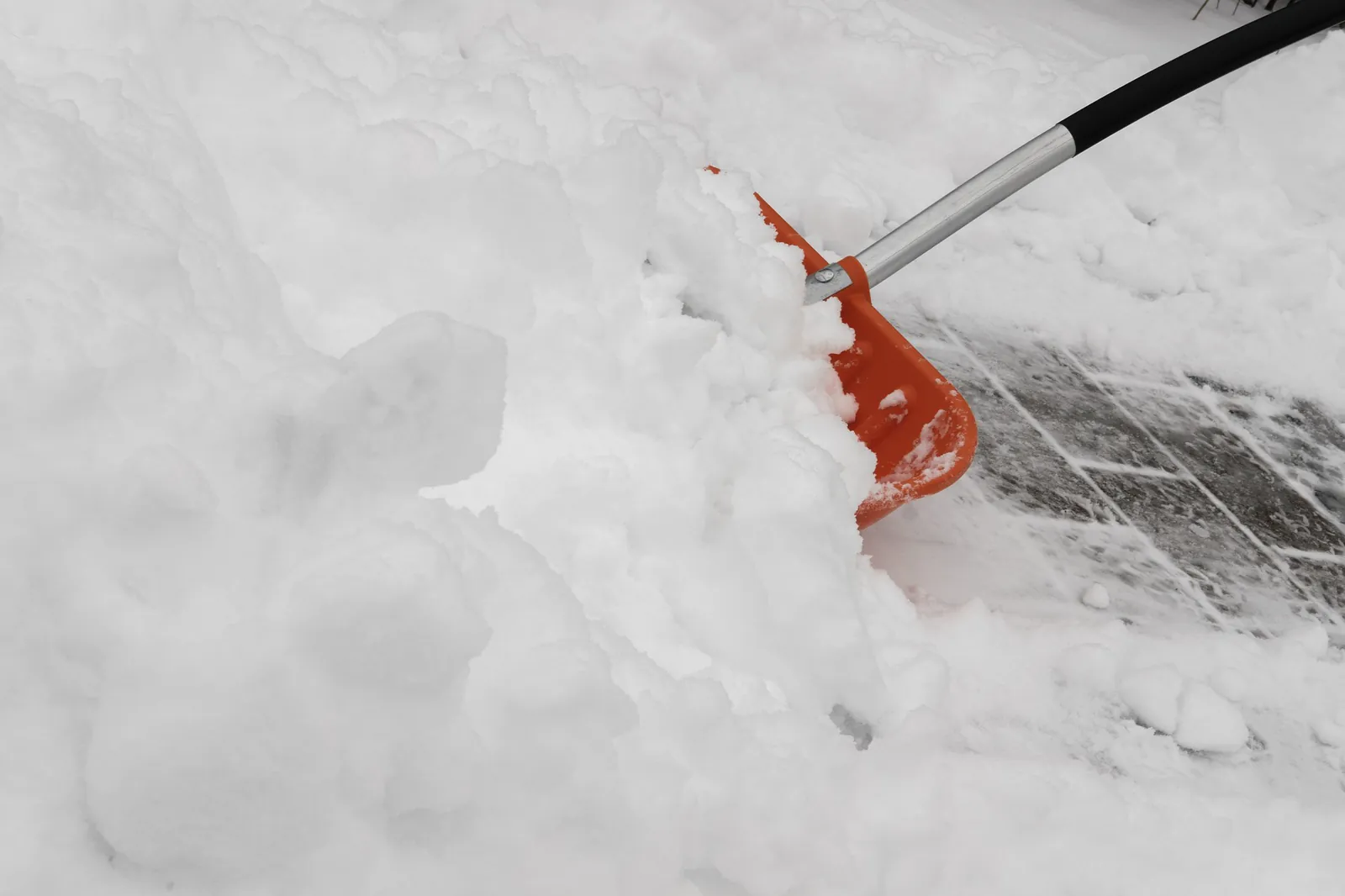 Person shoveling snow from a walkway